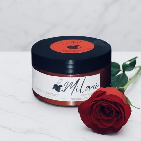 Body Butter container in front of a marble background.